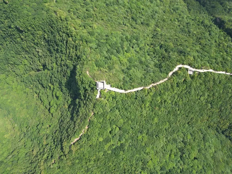 The grand skyline vista of the Great Wall stretching to the Beijing Knot