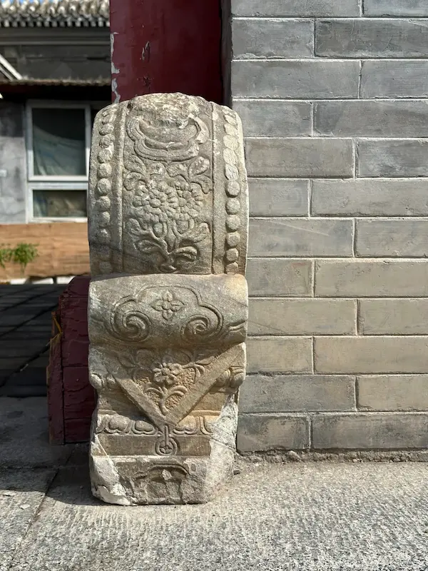 Exquisitely carved drum-shaped stone gate piers at the gate