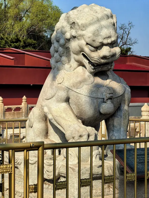 The stone lion at Tiananmen Square whose right paw rests on a embroidered ball